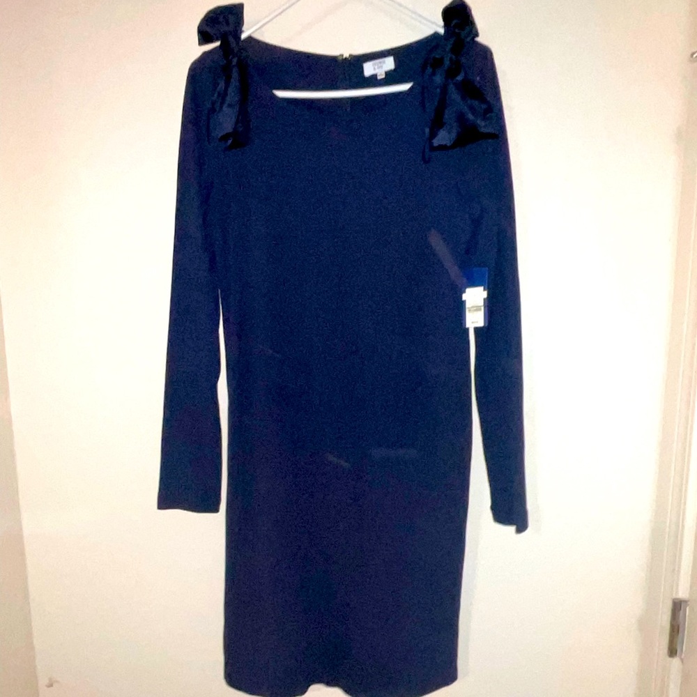 Knee length long sleeve dress with bows at the shoulder.